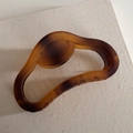 Detail of matte amber textured large hair claw clip made of resin on linen surface - Coffee Gradient