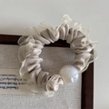 Close-up of cream satin scrunchie with lace edge and iridescent pearl detail - Mesh Edge Iridescent Bead - Apricot