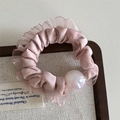 Detail of pink silk scrunchie with lace trim and iridescent pearl on a wooden tray - Mesh Edge Iridescent Bead - Pink