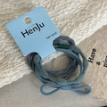 Detail view of elastic hair bands with ribbed texture and decorative bow on blue card - Blue