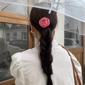 Detailed back view of a 3D pink satin rose hair scrunchie styled on dark hair - Rose Red