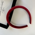 Elegant deep red velvet padded headband with handmade label on a clean white background - Red