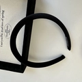 Detail of handmade black velvet padded headband with a focus on inner handmade label - Black
