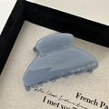 Detailed close-up of Morandi blue acetate hair claw with Barrette La France engraving - Blue