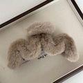 Close-up of soft light brown plush hair claw clip in a wooden tray, winter hair accessory - Light Coffee