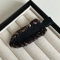 Detailed view of hand-knitted woolen texture on a vintage metal duckbill hair clip - Black