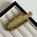 Detailed macro view of retro knitted wool hair clip with vintage matte gold metal base - Yellow