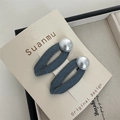 Detail view of denim fabric bow hair clips with white pearls on a display card - Denim Pearl BB Hair Clip
