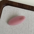 Pink oval acetic acid hair clip with France Handmade text on elegant linen background - Pink