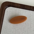 Caramel acetate oval hair clip with France engraving in a premium display tray - Orange