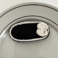 Close-up of handmade black and white crochet hair clip with a small white bow detail - Black Bow Style