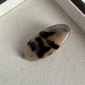 Macro view of oval tortoise shell acetate hair clip with gold France handmade logo - Tortoiseshell