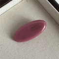 Close-up of pink oval acetate hair clip with FRANCE Handmade engraving on fabric tray - Pink