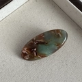 Macro detail of oval acetate hair clip featuring vintage marble texture and France engraving - Green & Coffee