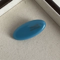 Close-up of a blue oval acetate hair clip featuring a France Handmade engraved logo - Blue