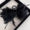 Detailed close-up of a large black hair claw clip with elegant ostrich feather decoration - Heavy Ostrich Feather Claw Clip - Black