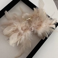 Detail showing elegant beige ostrich feathers on a large acrylic hair claw clip for women - Heavy Ostrich Feather Claw Clip - Beige