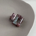 Detail shot of mini acetate square hair claw with marbled red-brown and blue texture - Coffee Green