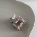Detailed macro view of a pink marble acetate hair claw clip showing handmade craft details - Pink Green