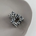 Detailed macro view of a handmade acetate mini hair claw with black and white spots - Black and White Spotted