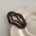 Close-up of a brown plush cloud hair clip with wave-shaped metal BB clip on a floral plate - Dark Coffee