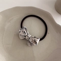 Macro detail of high-elastic bow hair tie with marble acetate and France Handmade text - Gray and White Pattern