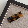 Close-up of a tortoiseshell acetate hair clip with FRANCE Handmade gold lettering - Tortoise