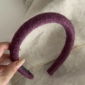 Detail view of a purple plush fleece headband with soft texture and inner black label - Purple