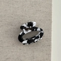 Close-up of acetic acid floral claw clip showing the FRANCE Handmade gold lettering - Hollow Small Oval - Black White