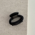 Detail view of a black acetate hair claw with gold France Handmade lettering - Hollow Small Oval - Black
