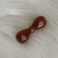 Detail of a brown acetate bow hair clip with gold Barrette La France lettering - Dark Coffee