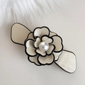 Dettaglio della clip per capelli a camelia crema con perla centrale e bordo nero a contrasto - Fiore in Acetato Bianco Latte - Base Larga