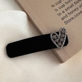 Detail of vintage black velvet hair clip with a sparkling rhinestone heart decoration - Hollow Heart Style