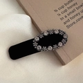 Macro detail of vintage black velvet hair clip with oval crystal rhinestones decoration - Oval Rhinestone Style