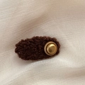 Close-up of fluffy dark brown faux fur hair clip with vintage golden button detail - Oval / Brown