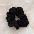 Close-up of black ribbed fabric scrunchie texture with elastic pleated design - Black Textured Scrunchie