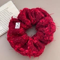 Macro detail of red tweed scrunchie with frayed edges and silver metallic thread - Burgundy