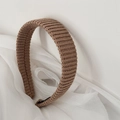 Close-up of brown striped knitted headband with soft woven texture on white fabric - Headband / Brown