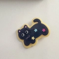Close-up of a cute dark purple cat hair clip with colorful stars and infinity symbol - Black Kitty