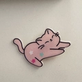 Detailed view of pink sleeping cat hair clip with colorful star patterns and matte finish - Pink Cat
