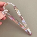 Close-up of elegant U-shaped acetate hair pin with pink and amber marble texture - Mermaid Purple