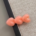 Nahaufnahme der pfirsichfarbenen Haarspange aus Acetat mit drei Herzen und Glanz - Wassermelonenrosa