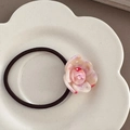 Detail of marbled acetate flower hair tie on white ceramic plate with elastic band - Pink & White