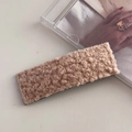 Detailopname van een rechthoekige haarclip in beige teddyvlies met een zwarte basis - Lamswol Rechthoekige BB Clip / Beige