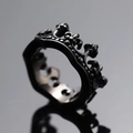 Macro shot of matte black punk crown ring with detailed dotted relief and smooth inner band - US 10 / Black