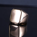 Close-up of a polished rose gold signet ring with a flat square top and reflective finish - Rose Gold