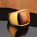 Detailed close-up of a vintage men's gold signet ring with a red tiger eye stone inlay - Gold Tiger's Eye