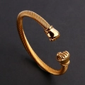 Men's gold stainless steel open cable bracelet featuring detailed fist charms at both ends - Gold