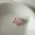 Close-up of pink star-shaped hair clip with inlaid rhinestones and engraved lettering - Star-Pink