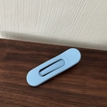 Detail of a minimalist oval light blue matte hair clip on a dark wood and white background - Blue